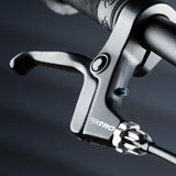 Close up on the brake on the Early rider auto belter bike showing a rubber handle bar and short levers