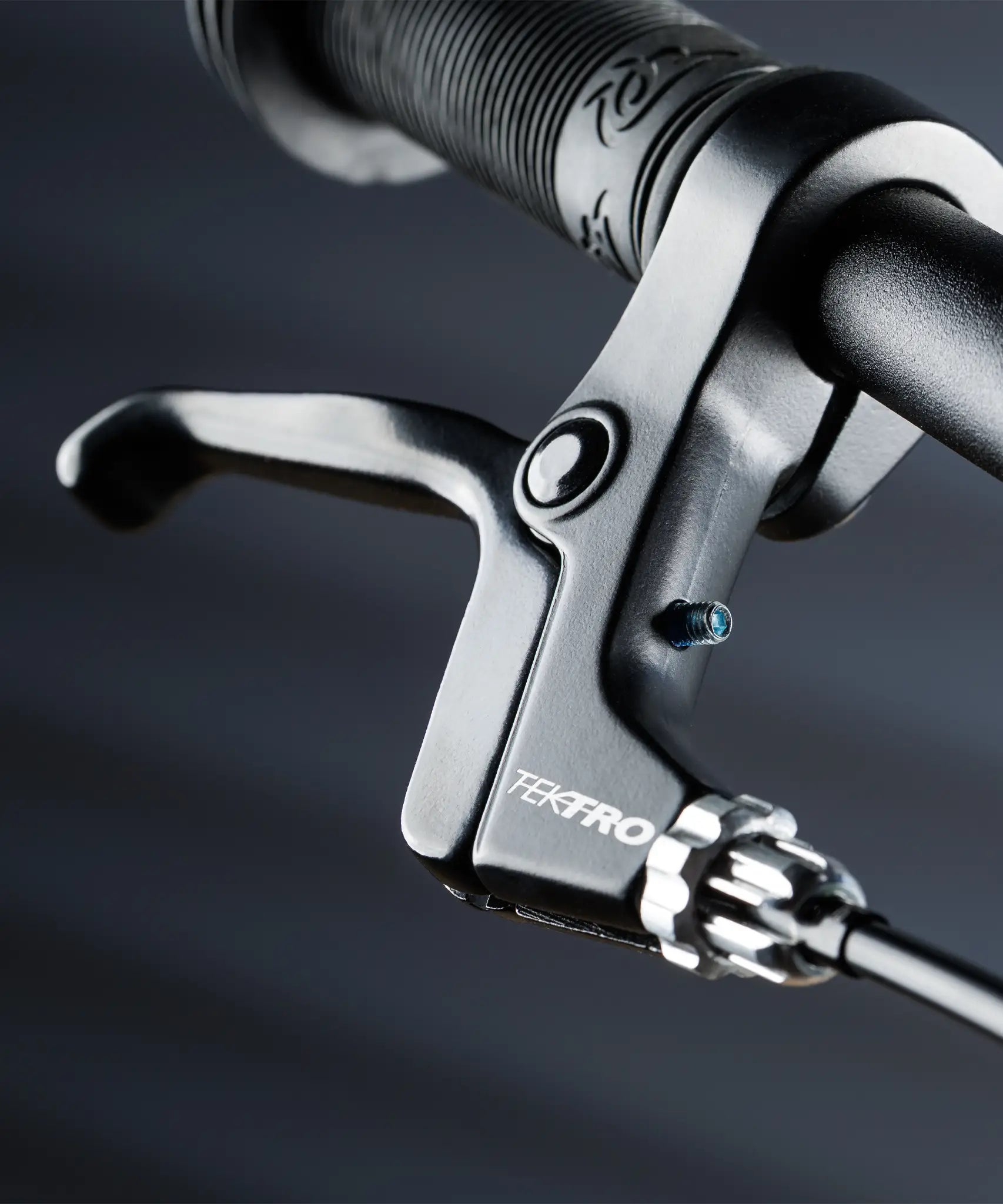 Close up on the brake on the Early rider auto belter bike showing a rubber handle bar and short levers