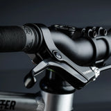 Close up of the brake and black rubber handle on the Early Rider auto belter bike