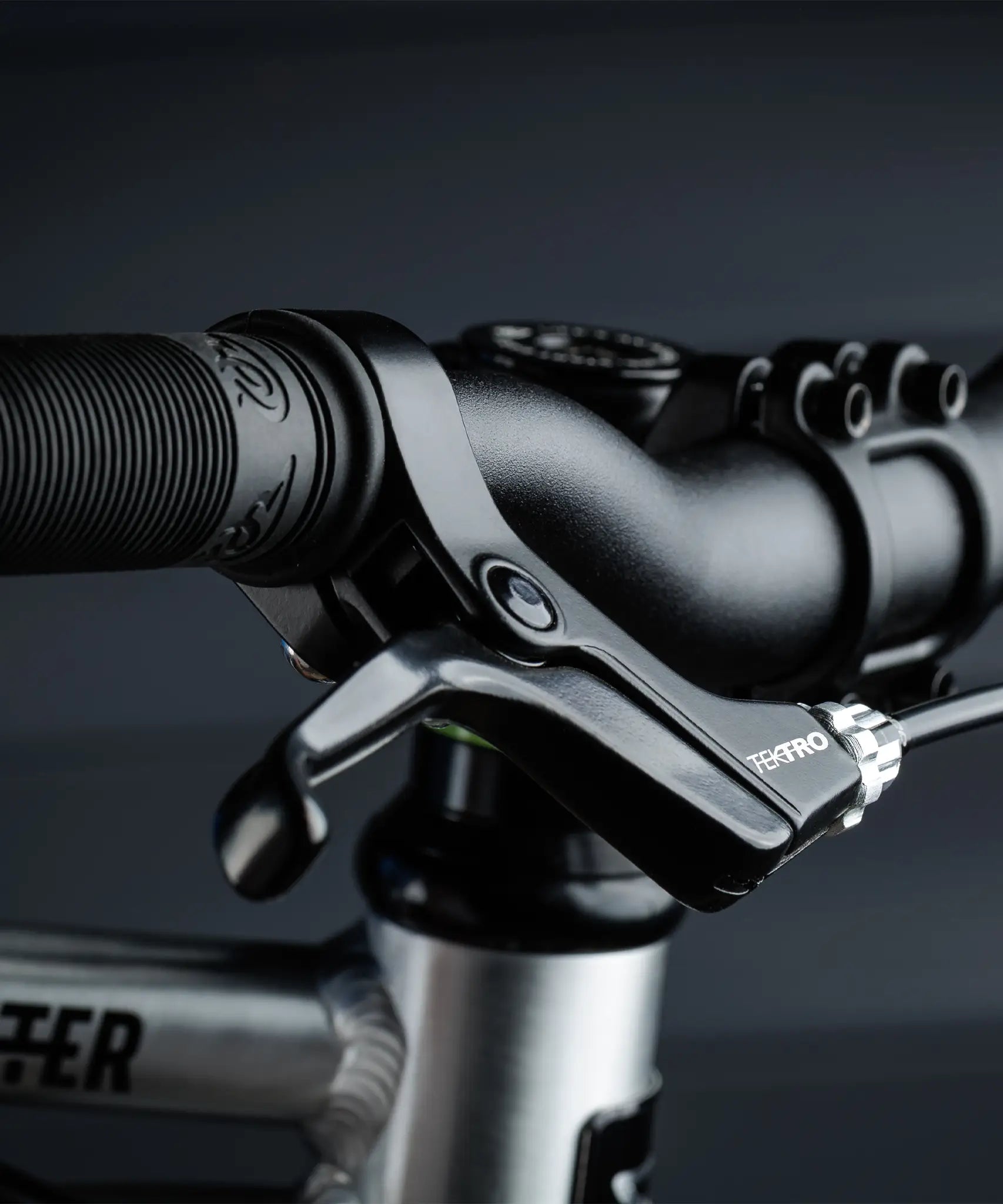 Close up of the brake and black rubber handle on the Early Rider auto belter bike