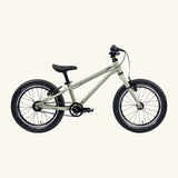 Side of Early Rider's 16 inch belter auto bike in sage green aluminium frame with black handle bars, seat and chunky wheels. 