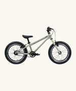 Side of Early Rider's 16 inch belter auto bike in sage green aluminium frame with black handle bars, seat and chunky wheels. 