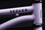Close-up of Early Rider 'SEEKER' children's bike frame with 'Seeker' branding on a dark background