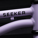 Close-up of Early Rider 'SEEKER' children's bike frame with 'Seeker' branding on a dark background