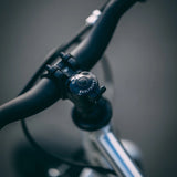 Close-up of Early Rider Belter 16 inch wheel children's bike handlebar with a blurred background