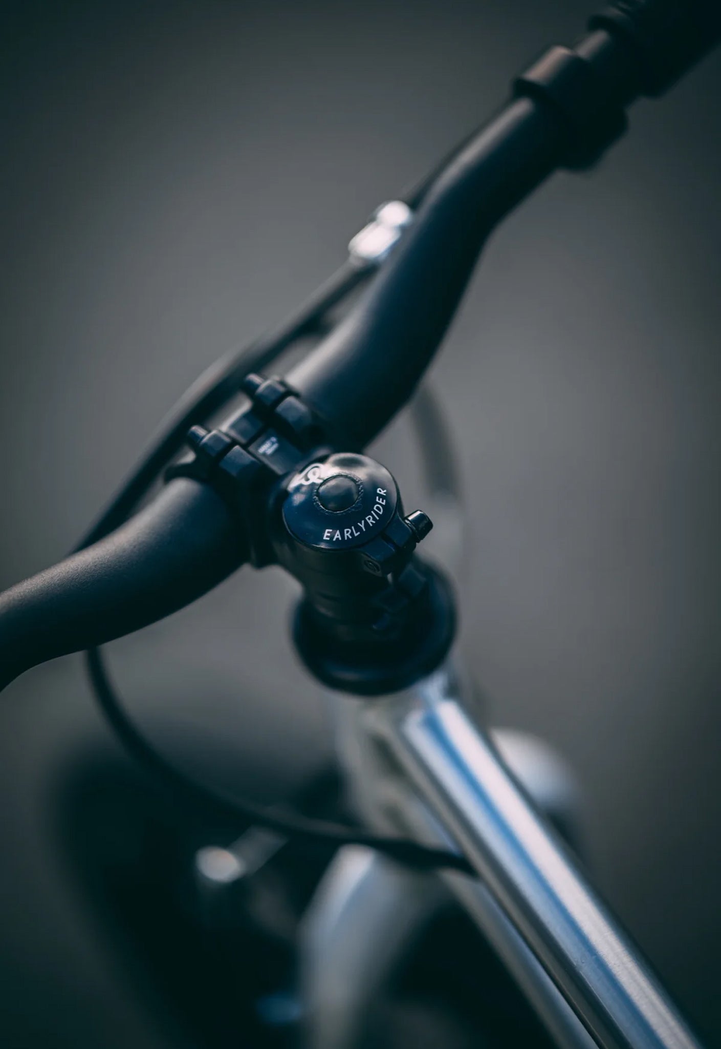 Close-up of Early Rider Belter 16 inch wheel children's bike handlebar with a blurred background