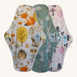 Three Earthwise reusable period pads in cute woodland prints.