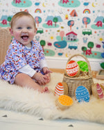 Rainbow Easter Eggs by Lanka Kade, made from wood, in a basket in the Babipur playroom, played with by baby.