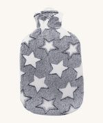 Ecoliving Natural Rubber Hot Water Bottle - Stella, has a super soft and snuggly plush cover in grey with a pattern of large white stars. The image is on a cream background
