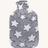 Ecoliving Natural Rubber Hot Water Bottle - Stella, has a super soft and snuggly plush cover in grey with a pattern of large white stars. The image is on a cream background