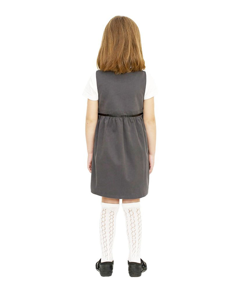 The back of a little girl wearing the Eco Outfitters organic and fair trade cotton school pinafore dress in grey