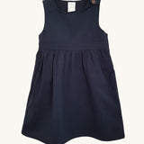 The Eco Outfitters organic and fair trade cotton school pinafore dress in navy.