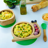 Eco Rascals Snail Plate, Feeder Cup, Bowl & Spoon Gift Set in green, with various food items surrounding