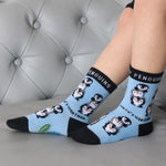 A close up of a child wearing the Eco kiddies organic cotton friendly penguins socks showing the cute playful penguin design detail and branding on the sole 