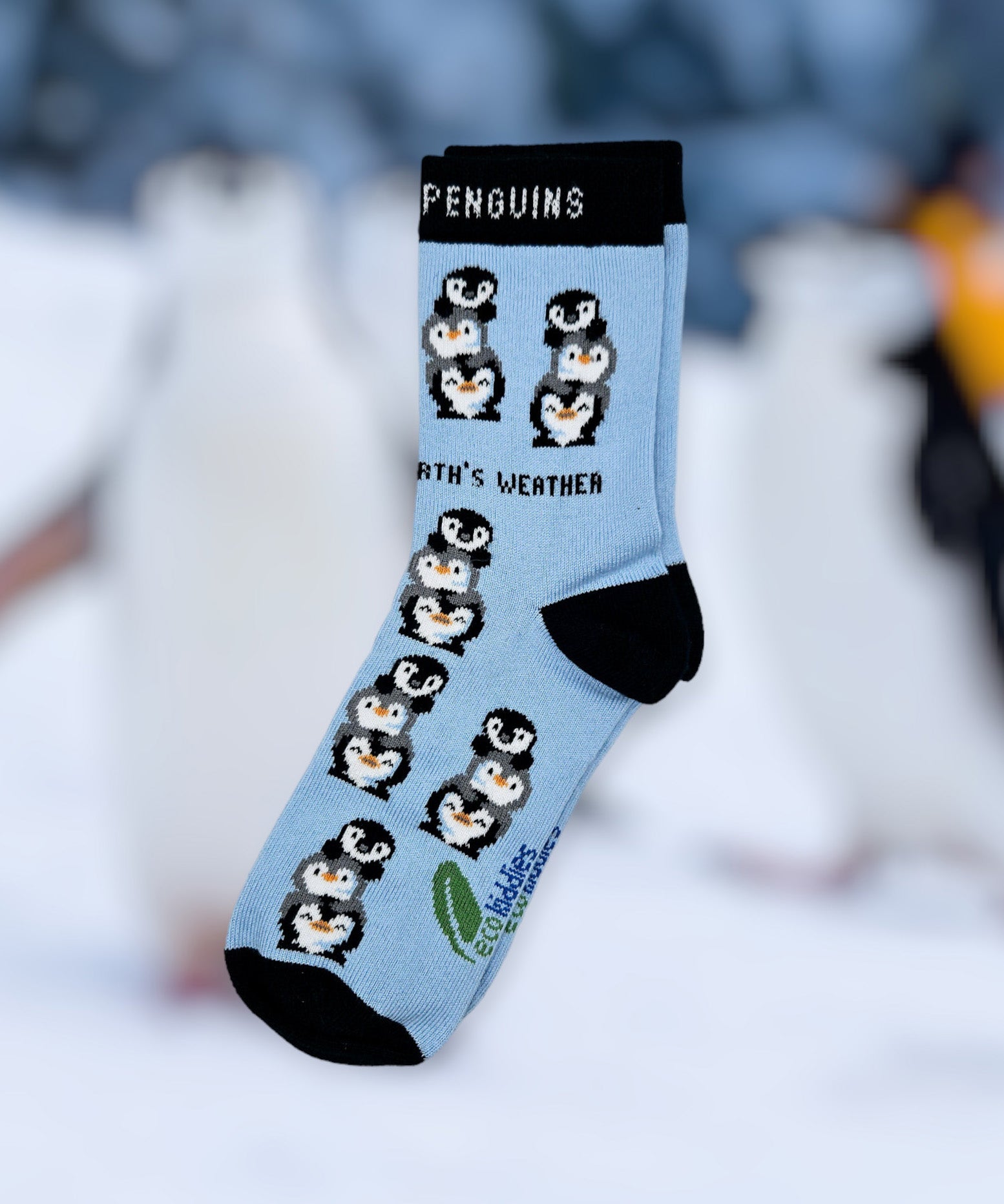 Eco kiddies light blue friendly penguins organic cotton kids socks on a blurred winter background