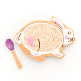 Bamboo rabbit kids plate with porridge and a bamboo and purple silicone baby spoon. 