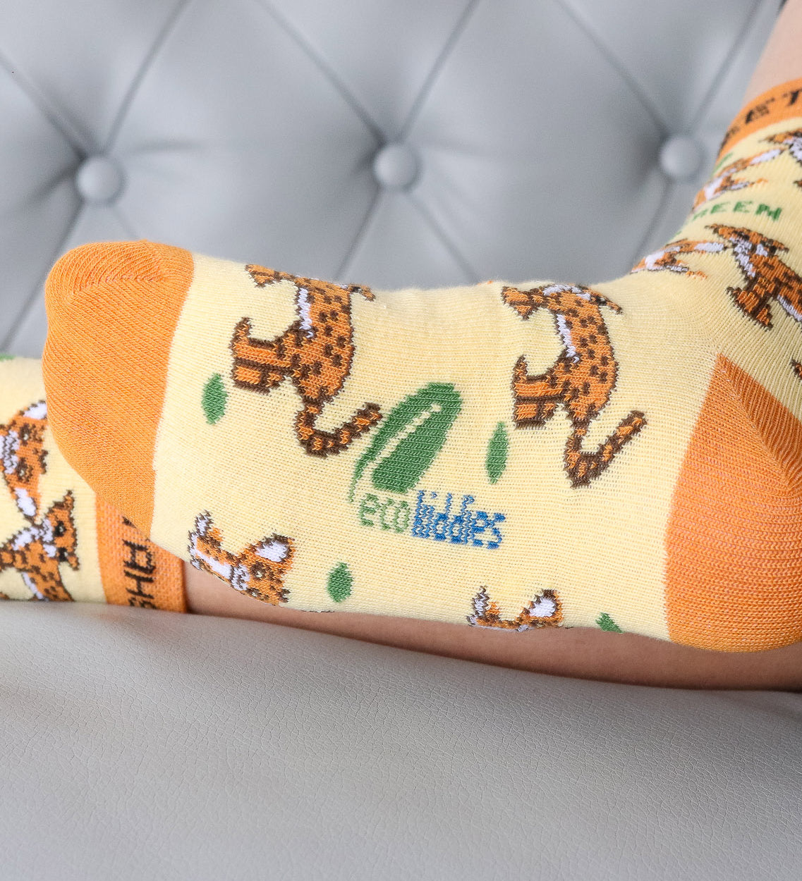 A close up of the Eco Kiddies organic cotton cheetah socks showing the cute cheetah design and the branding on the sole
