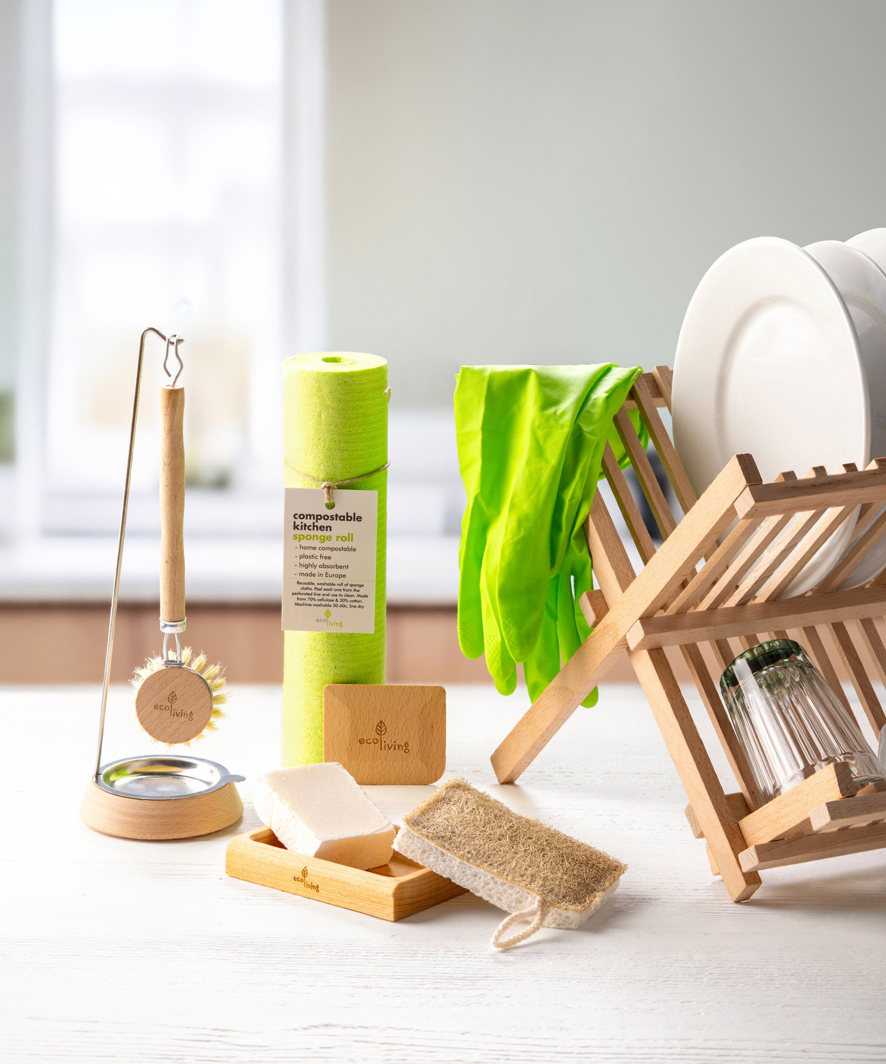 Ecoliving loofah kitchen sponge scrubber available at Babipur in a kitchen setting next to other Ecoliving kitchen items such as the wooden dish drainer.