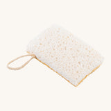 A image of the sponge side of the Ecoliving loofah kitchen sponge scrubber available at Babipur. A double sided scrubber, features a loofah side and a sponge side with a loop of thread for hanging. 