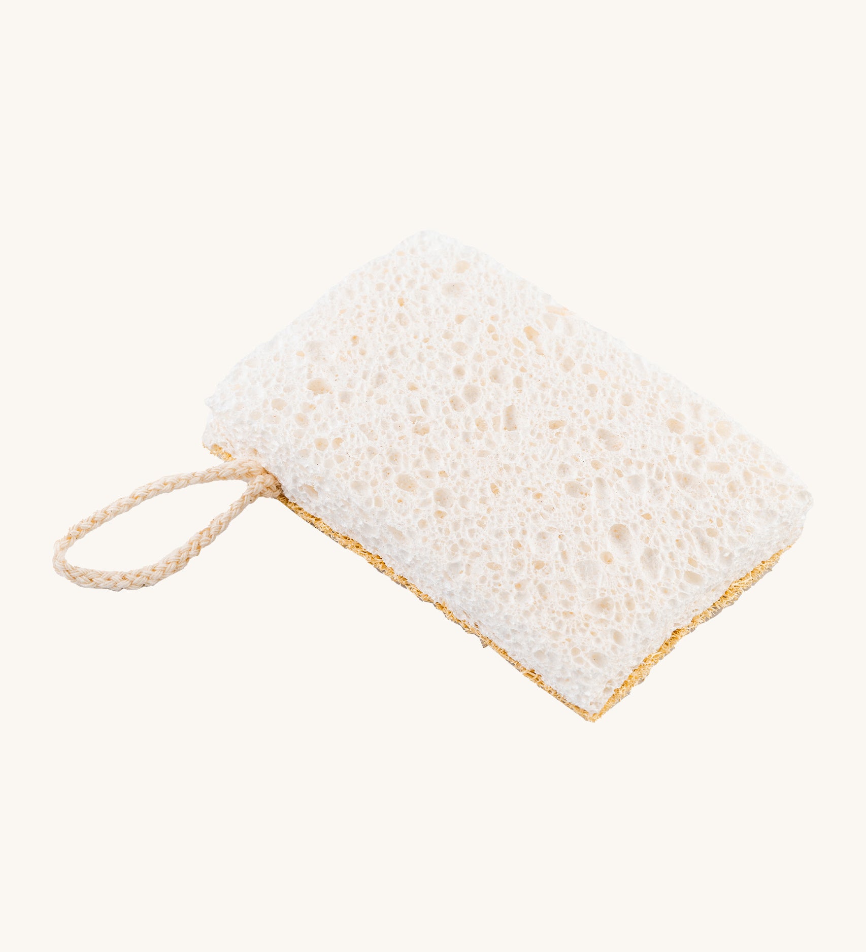 A image of the sponge side of the Ecoliving loofah kitchen sponge scrubber available at Babipur. A double sided scrubber, features a loofah side and a sponge side with a loop of thread for hanging. 