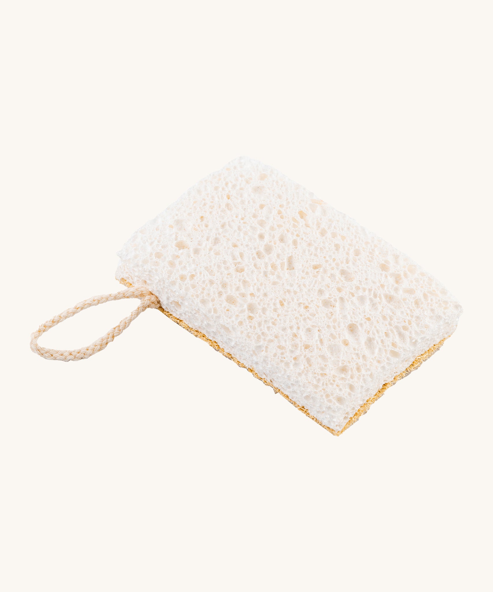 A image of the sponge side of the Ecoliving loofah kitchen sponge scrubber available at Babipur. A double sided scrubber, features a loofah side and a sponge side with a loop of thread for hanging. 