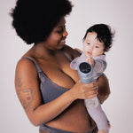 A parent holding their child, with the child reaching towards the Lola&Lykke Smart Electric Breast Pump