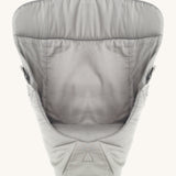 Ergobaby Baby Carrier insert in Grey, on a cream background. The image shows the Carrier Insert from the front with the seat cushion inside the insert