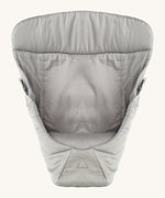 Ergobaby Baby Carrier insert in Grey, on a cream background. The image shows the Carrier Insert from the front with the seat cushion inside the insert