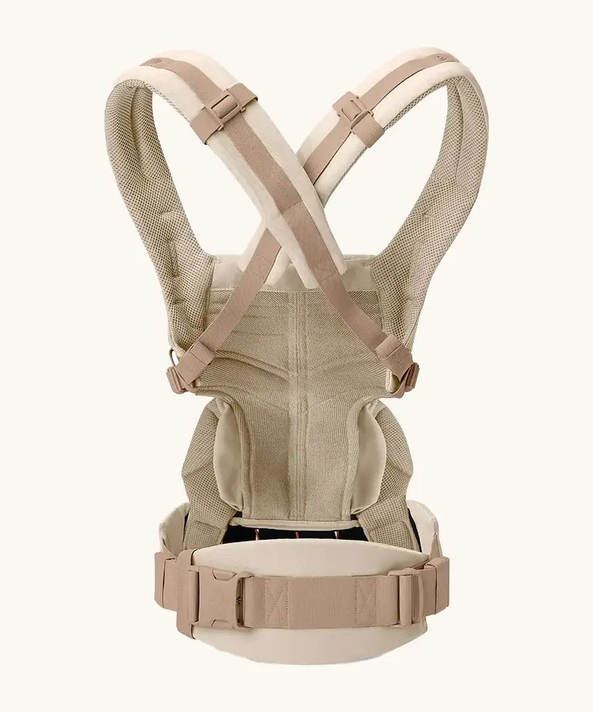 Back of Ergobaby omni 360 baby carrier in natural beige showing crossable straps configuration