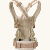 Back of Ergobaby omni 360 baby carrier in natural beige showing crossable straps configuration