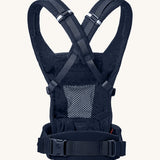 Ergobaby Adapt  SoftFlex™ Mesh Baby Carrier in Midnight Blue. Back view showing cross over shoulder straps. 