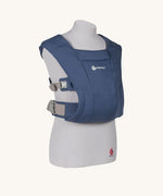 The Ergobaby Soft & Snug knit newborn baby carrier in a soft navy colour, from a side angle view.