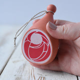 Erzi Gammon joint Wooden Play Food in an adult's hand.
