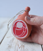 Erzi Gammon joint Wooden Play Food in an adult's hand.