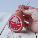 Erzi Gammon joint Wooden Play Food in an adult's hand.