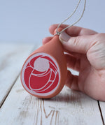 Erzi Gammon joint Wooden Play Food in an adult's hand.
