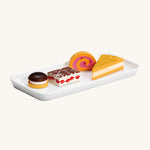 The Erzi Wooden Cream Pastries In A Tin, on a long white plate, with a cream background
