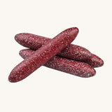 A closer look at the painted Erzi  Wooden Mini Salami, painted to resemble real salami. On a cream background
