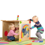 A child playing with the sun cog on the Erzi Sensory Weather Wall Board, with a child sat inside a sensory wall board den