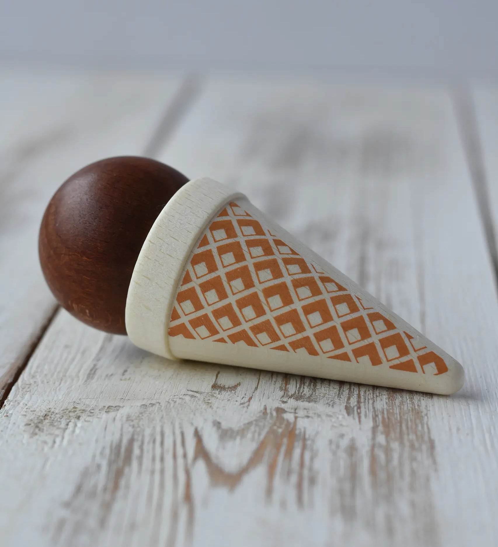 Erzi brown chocolate ice cream cone wooden toy play food placed on a wooden surface.