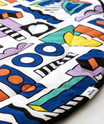 A closer look at the colourful print and shapes on the Etta Loves x Camille Walala Reversible Playmat
