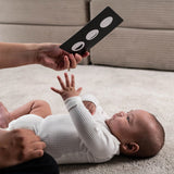 A parent playing with their child, using the Etta Loves Sensory Positive Affirmation Flash Cards