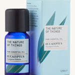 Organic Eucalyptus pure essential oil in a blue glass bottle in front of a decorative blue cardboard box.