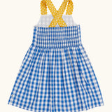 Frugi 100% organic cotton dress in blue and white gingham showing yellow shoulder straps and elasticated back panel