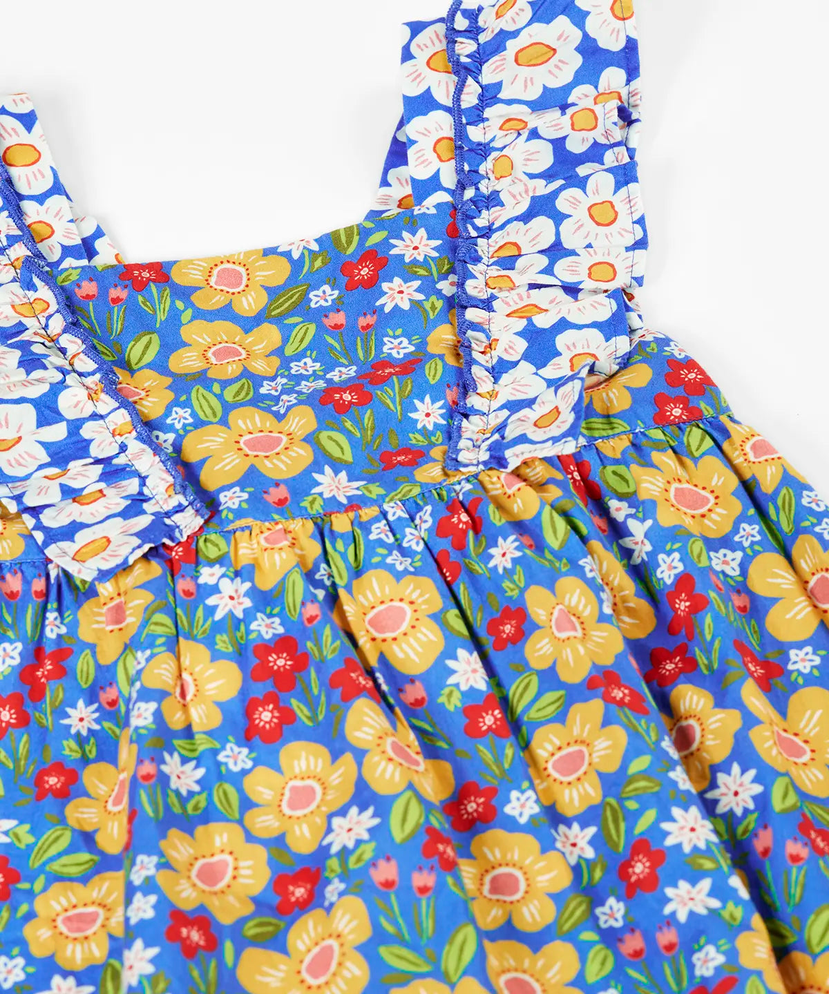 Frugi 100% organic cotton Audrey dress in blue laid flat showing the different repeating floral design.and shoulder straps
