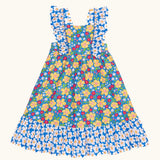 Frugi 100% organic cotton Audrey dress in blue with a repeating floral design. Showing frill on shoulder straps