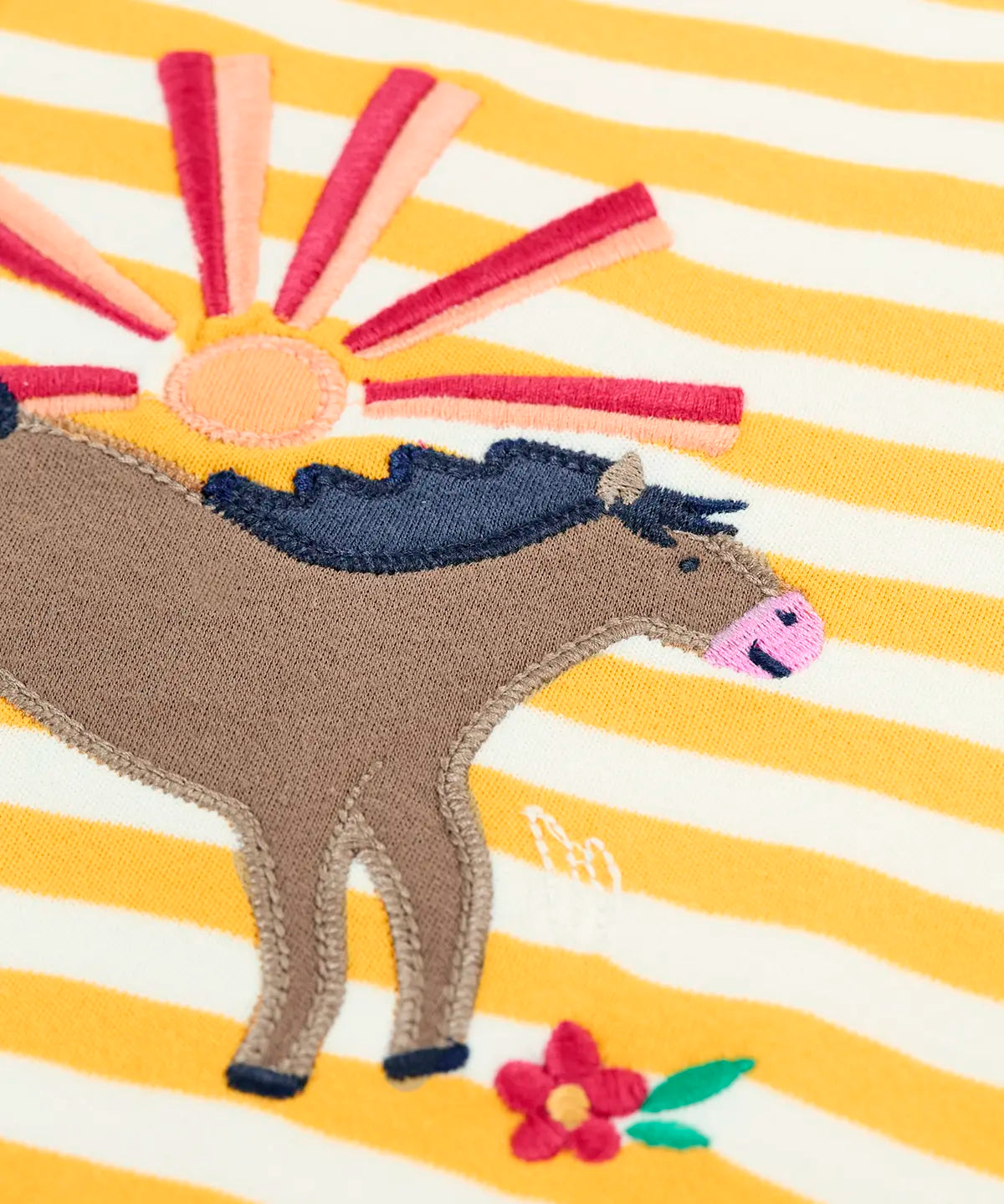 Close up of brown jumping horse patch on the Frugi 100% organic cotton short sleeve t-shirt in yellow and white stripe 