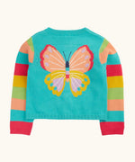 Frugi 100% organic cotton cardigan in light blue with rainbow striped sleeves showing large butterfly embroidery on upper back