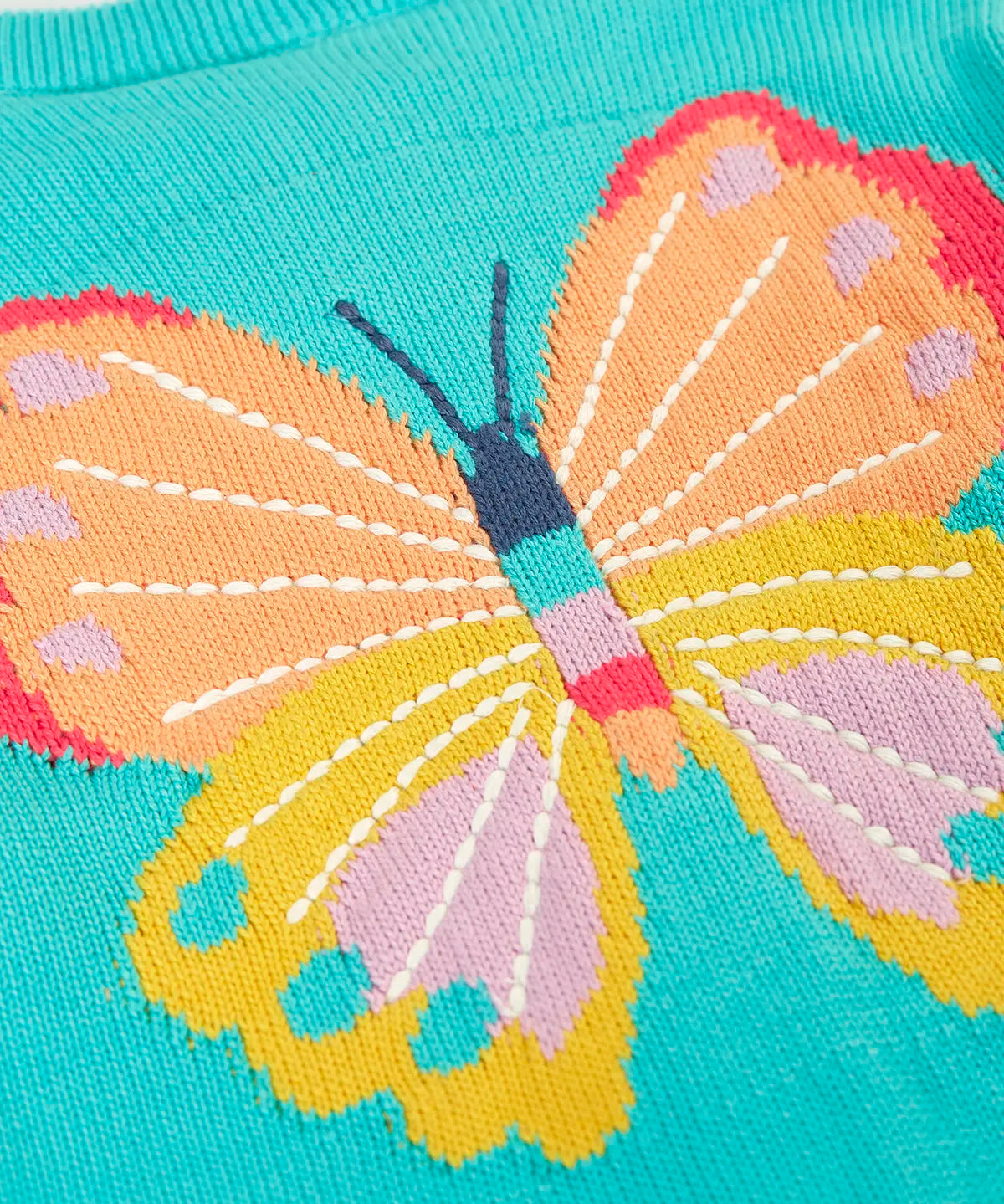 Close up of large butterfly embroidery on Frugi's 100% organic cotton cardigan in light blue 