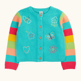 Frugi 100% organic cotton cardigan in light blue with rainbow striped sleeves and spring inspired embroideries on front. Showing full length front button fastener